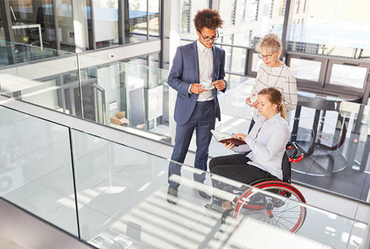 Disabled person in wheelchair at professional workplace