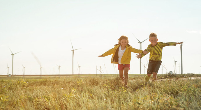 Kids playing in a large field.